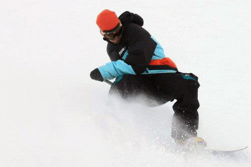Snowboarder using the Kahuna Creations Snow Grip on a land paddle.