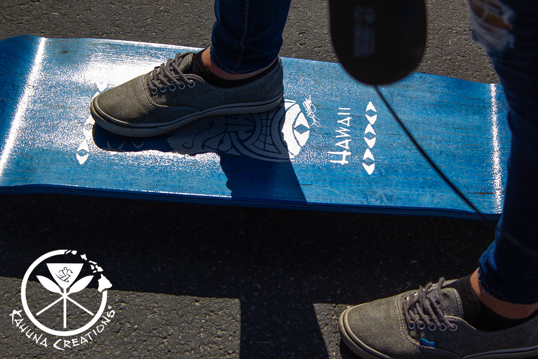 woman standing on Kahuna Creations drop deck longboard