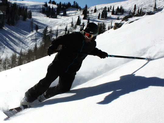 Snowboarder using the Kahuna Creations Snow Grip on a land paddle.